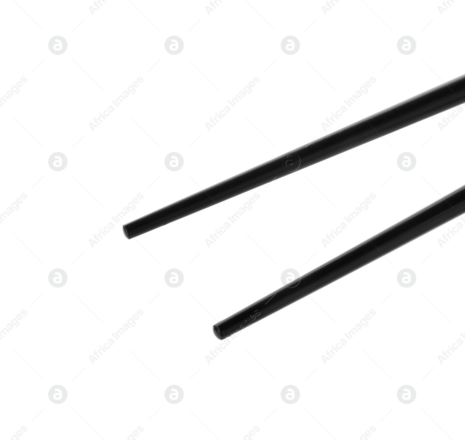 Photo of Pair of black chopsticks isolated on white