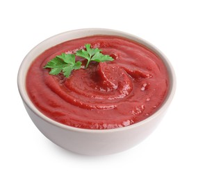 Organic ketchup and parsley in bowl isolated on white. Tomato sauce