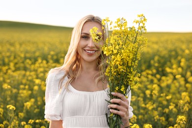 Portrait of happy young woman in field on spring day