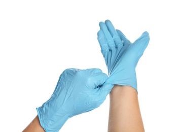 Doctor wearing medical gloves on white background