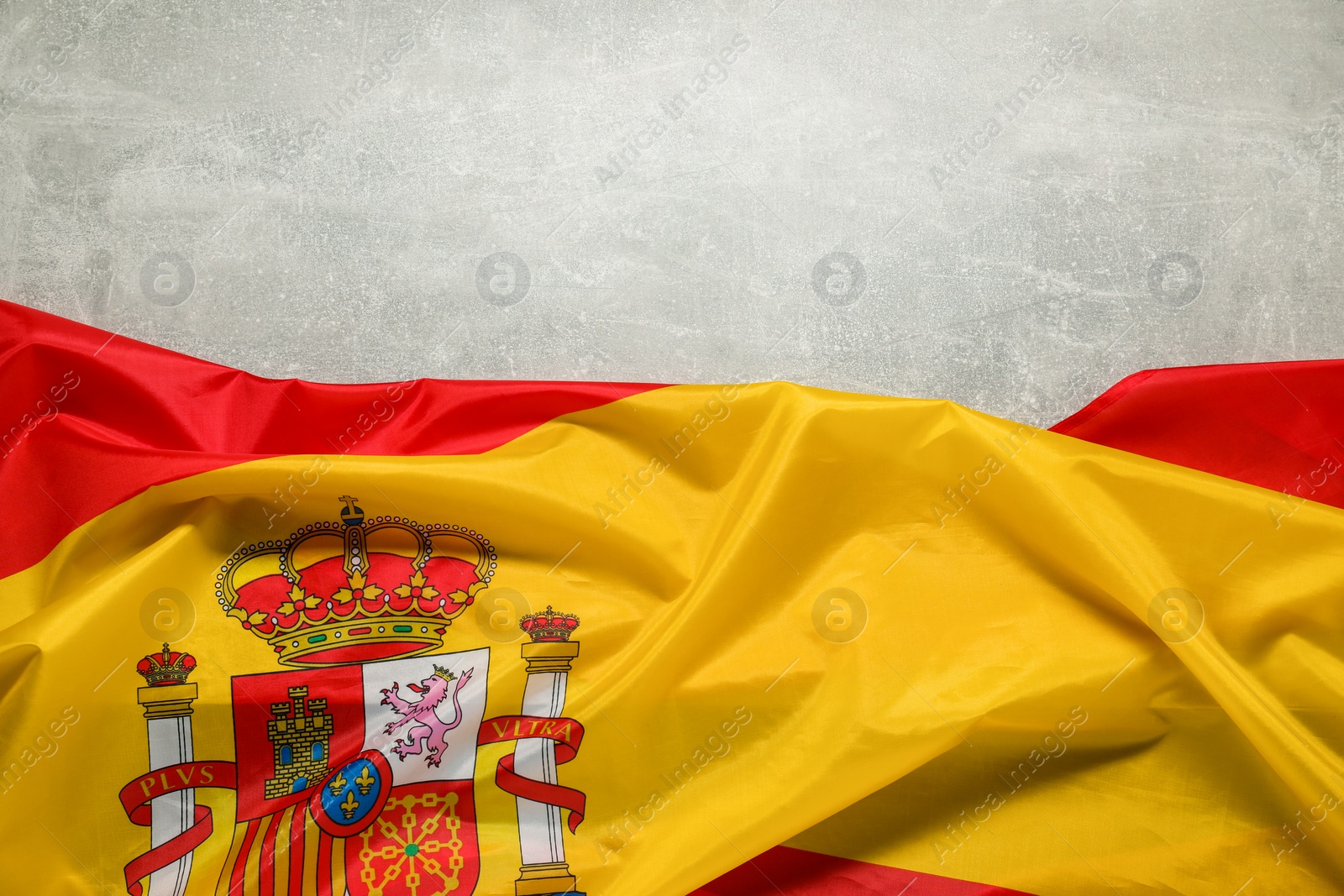 Photo of Flag of Spain on light gray textured background, top view. Space for text