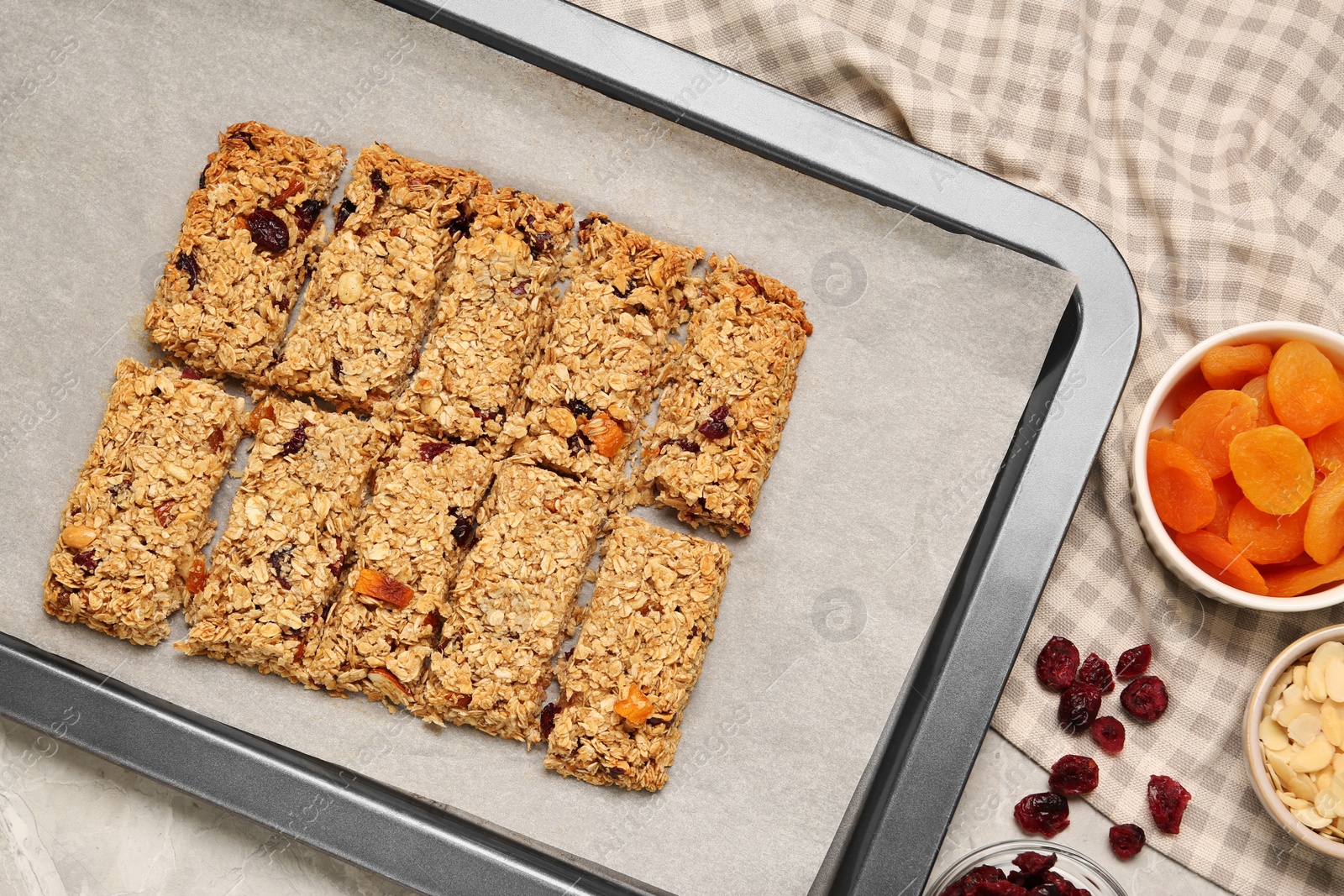 Photo of Tasty granola bars and ingredients on table, flat lay