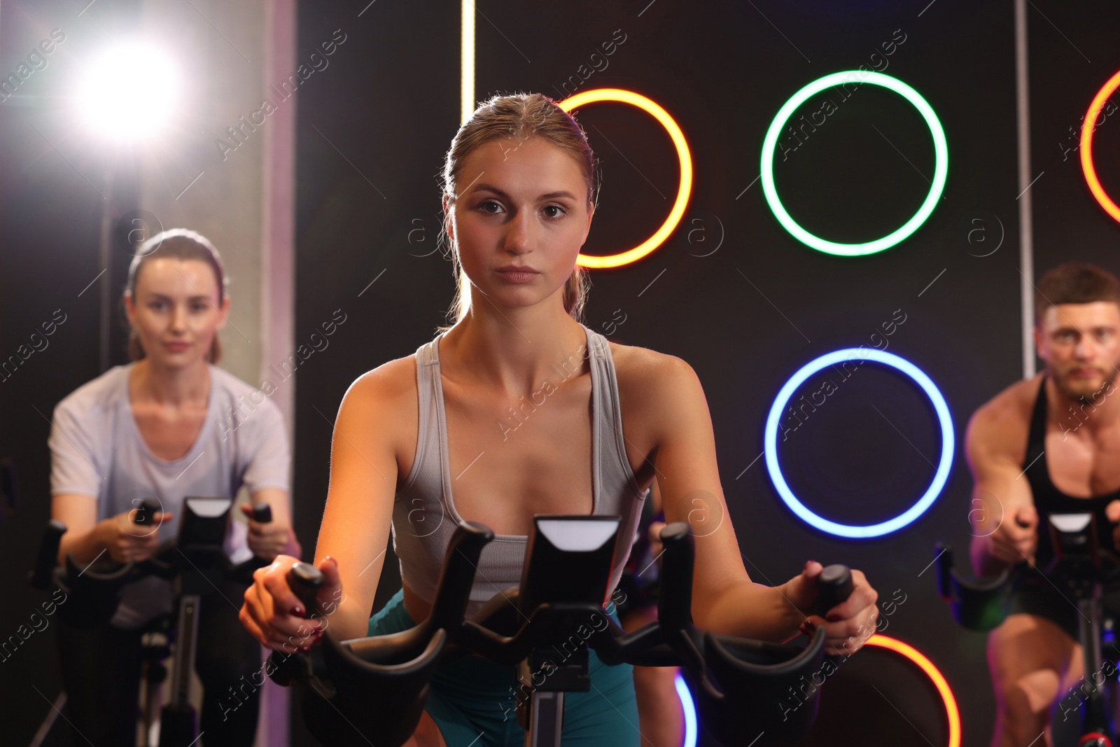 Photo of Group of people training on exercise bikes in fitness club