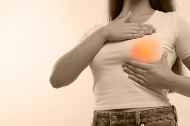 Image of Woman doing breast self-examination on light background, closeup. Color accent effect