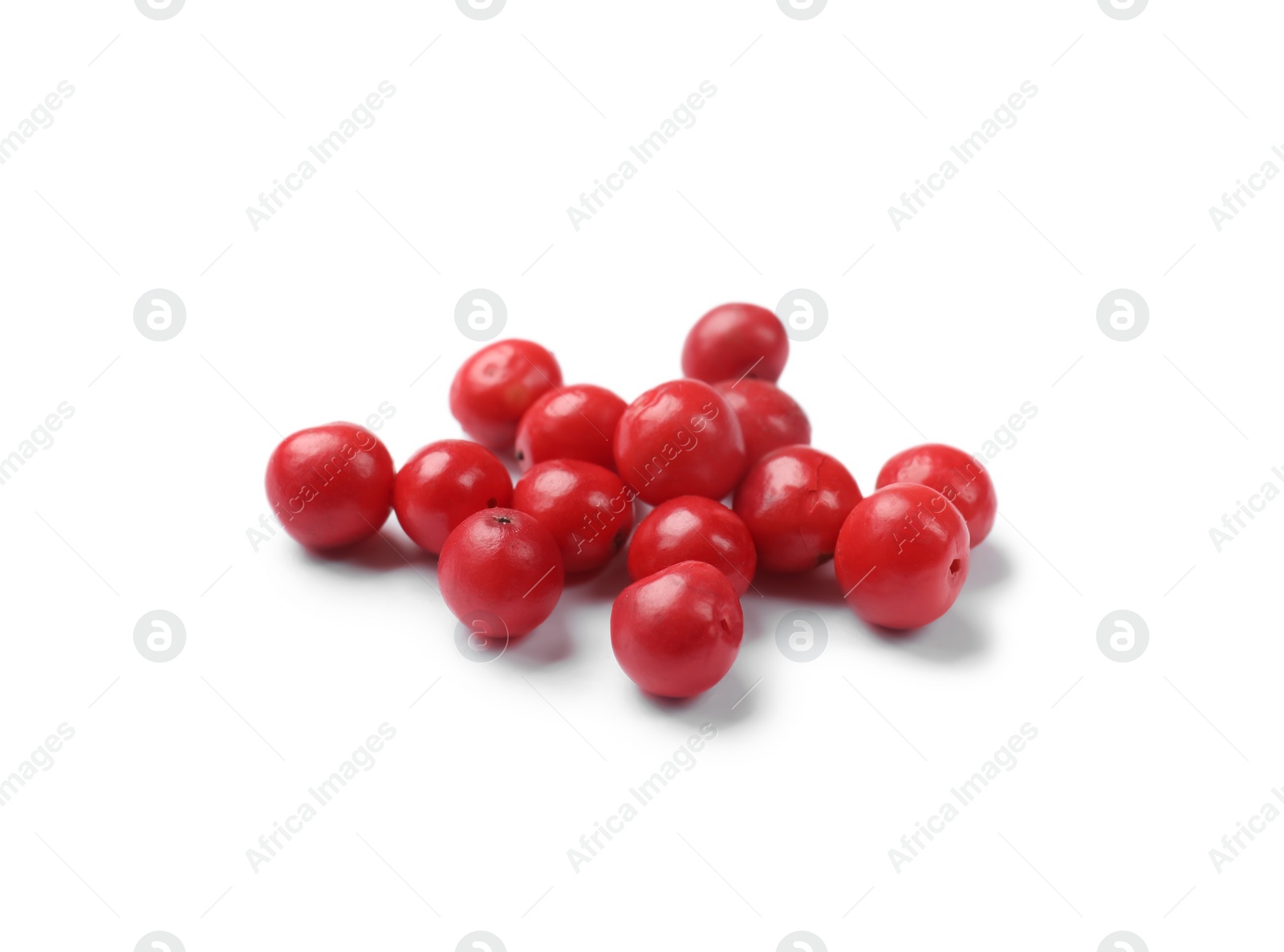 Photo of Aromatic spice. Many red peppercorns isolated on white