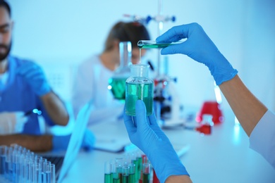Medical student working in modern scientific laboratory, closeup