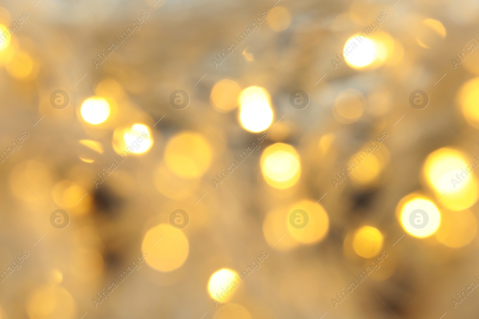 Photo of Blurred view of glowing Christmas lights, closeup