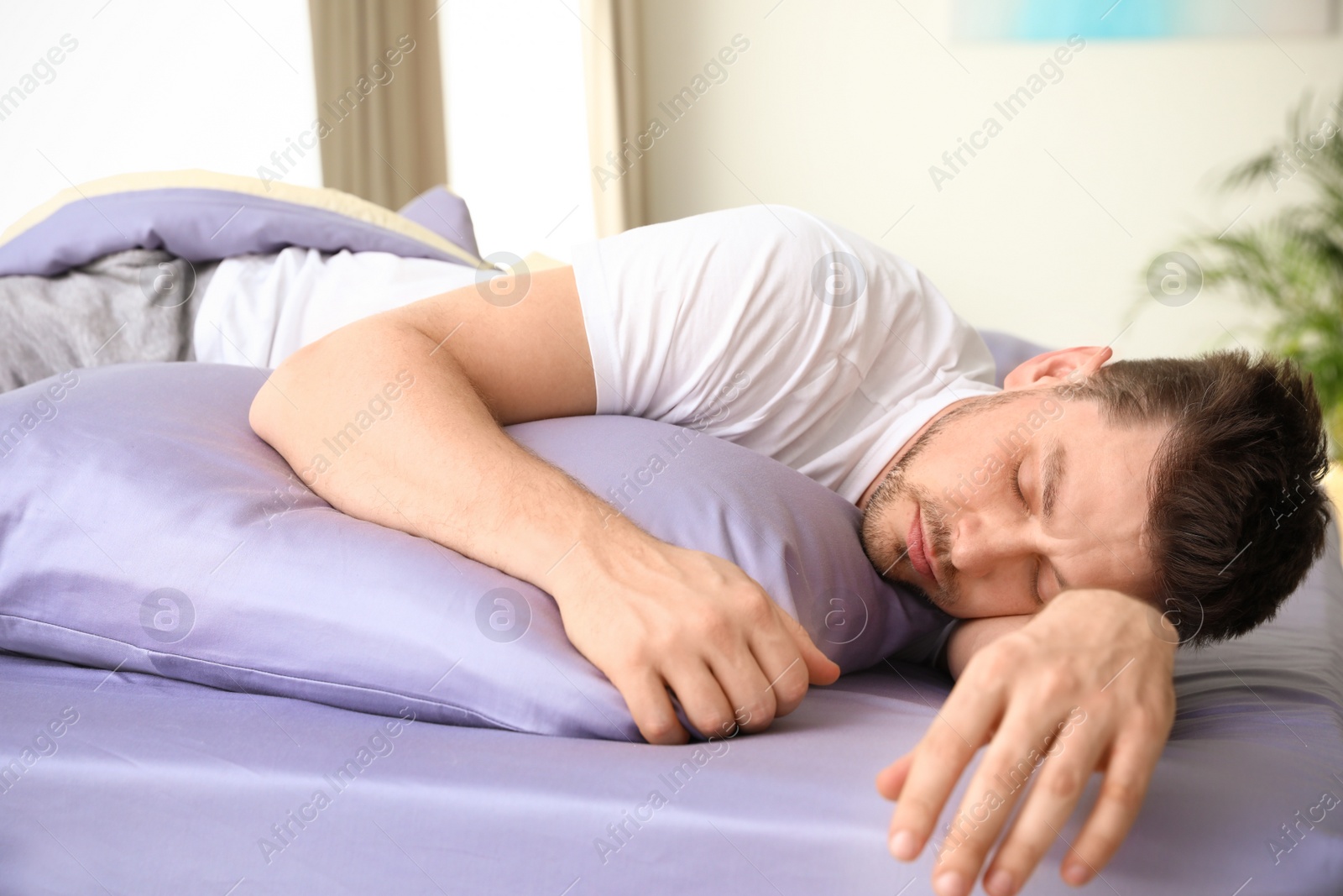 Photo of Handsome man sleeping on pillow at home. Bedtime