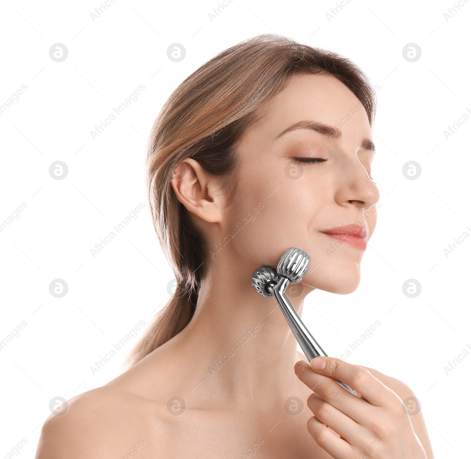 Photo of Young woman using metal face roller on white background