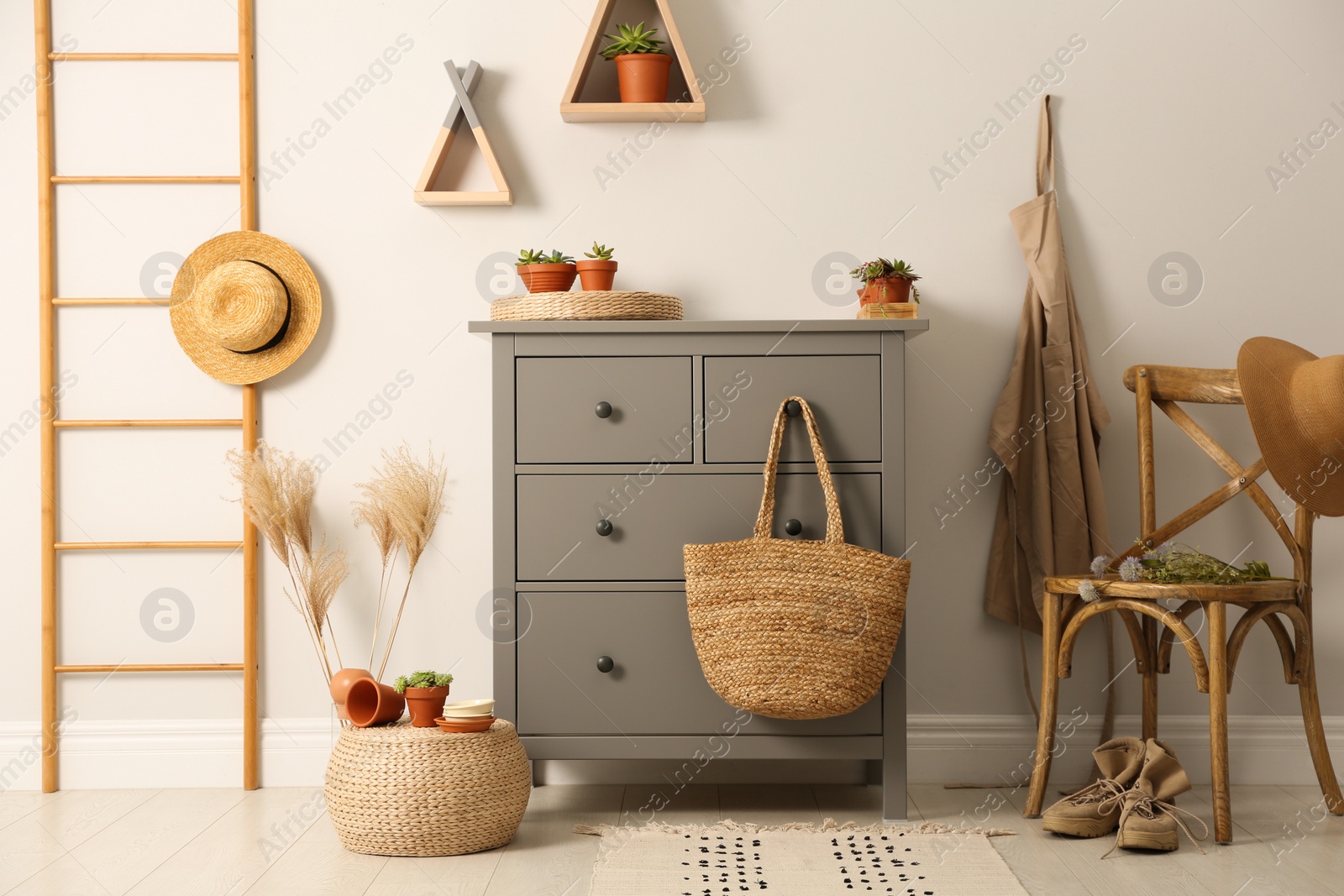 Photo of Grey chest of drawers in stylish room interior