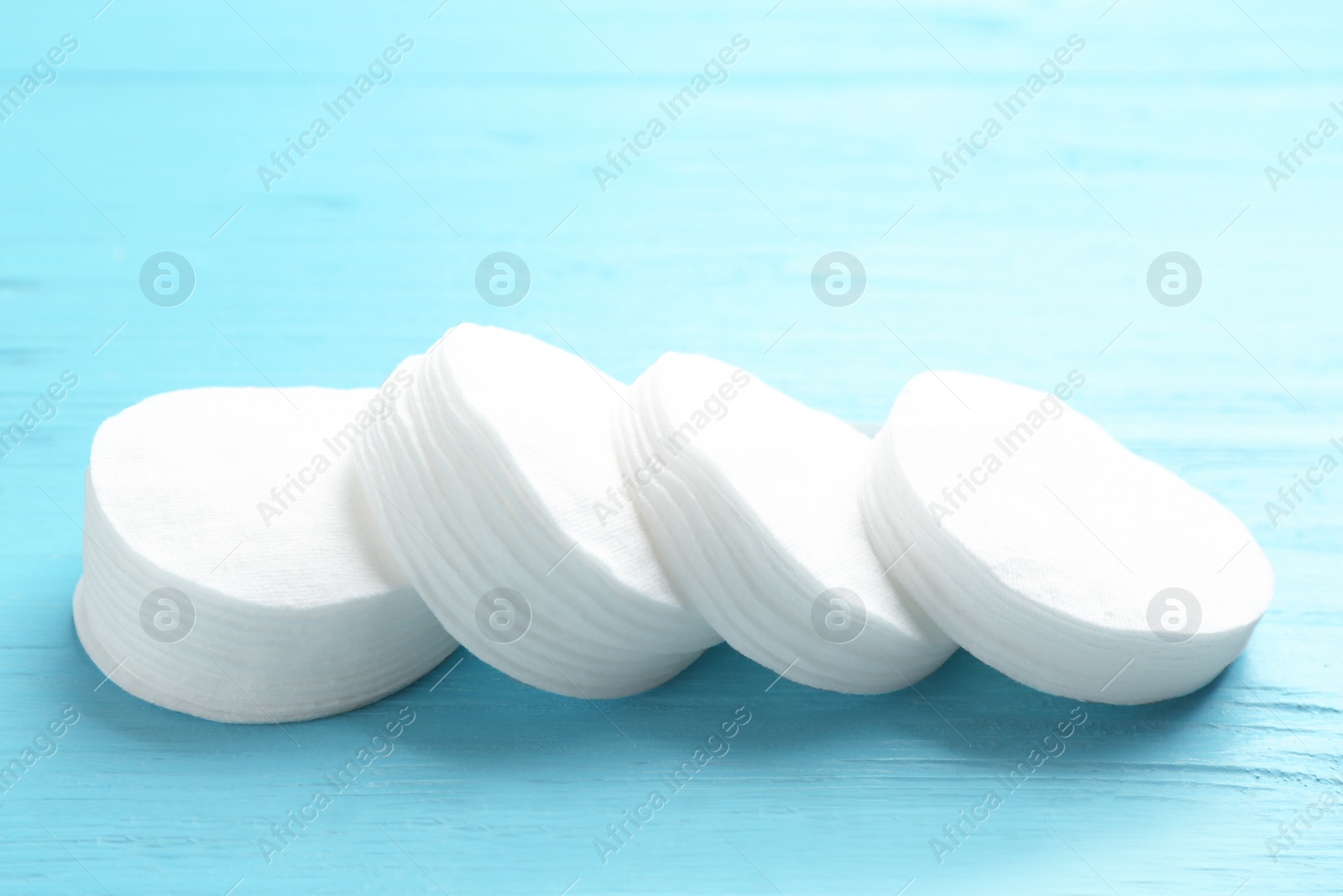 Photo of Cotton pads on wooden background. Hygienic product