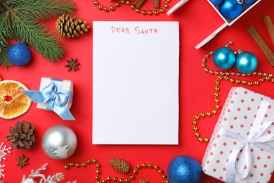 Photo of Flat lay composition with paper and Christmas decor on color background. Letter for Santa Claus