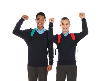 Photo of Portrait of teenage boys in school uniform with backpacks on white background