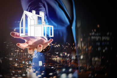 Image of Double exposure of real estate agent with house illustration and night city