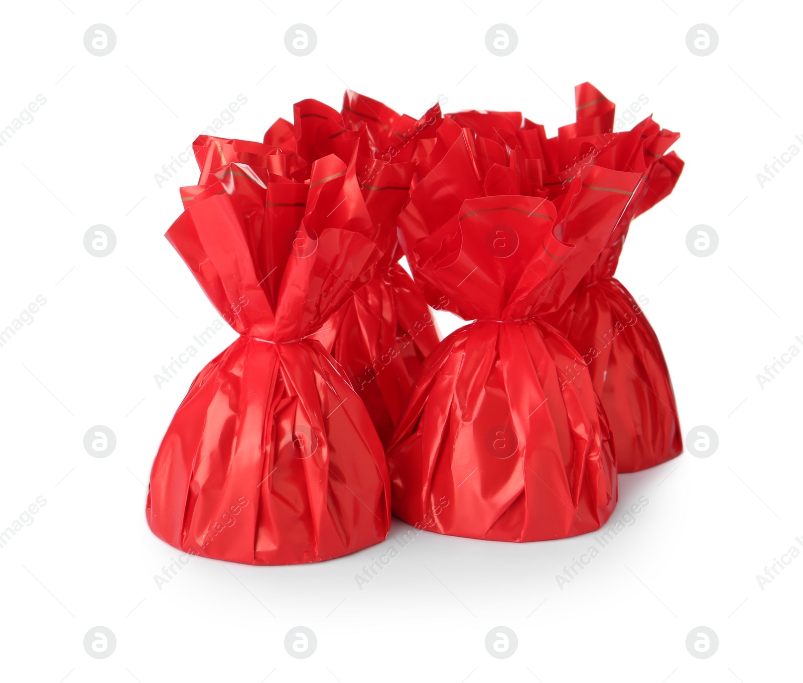 Photo of Delicious candies in red wrappers on white background