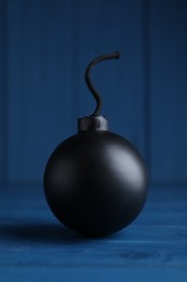 Photo of Old fashioned fuse bomb on blue wooden table
