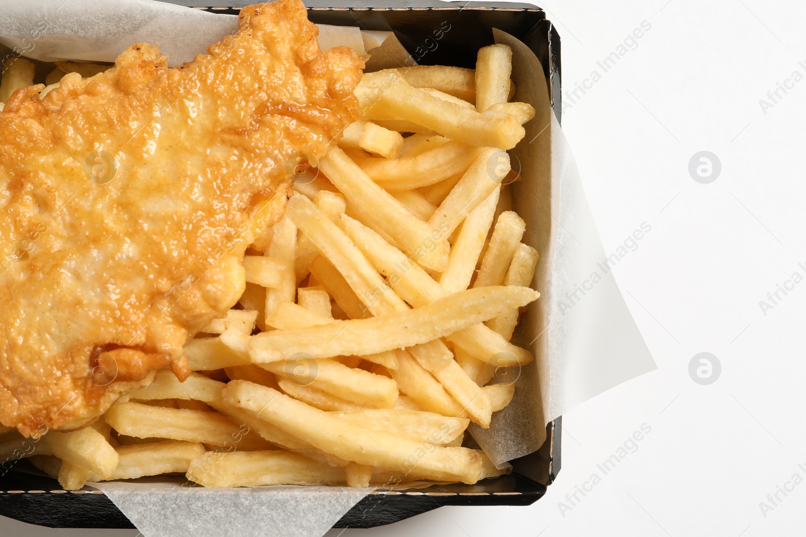 Photo of Disposable container with British Traditional Fish and potato chips on white background, top view