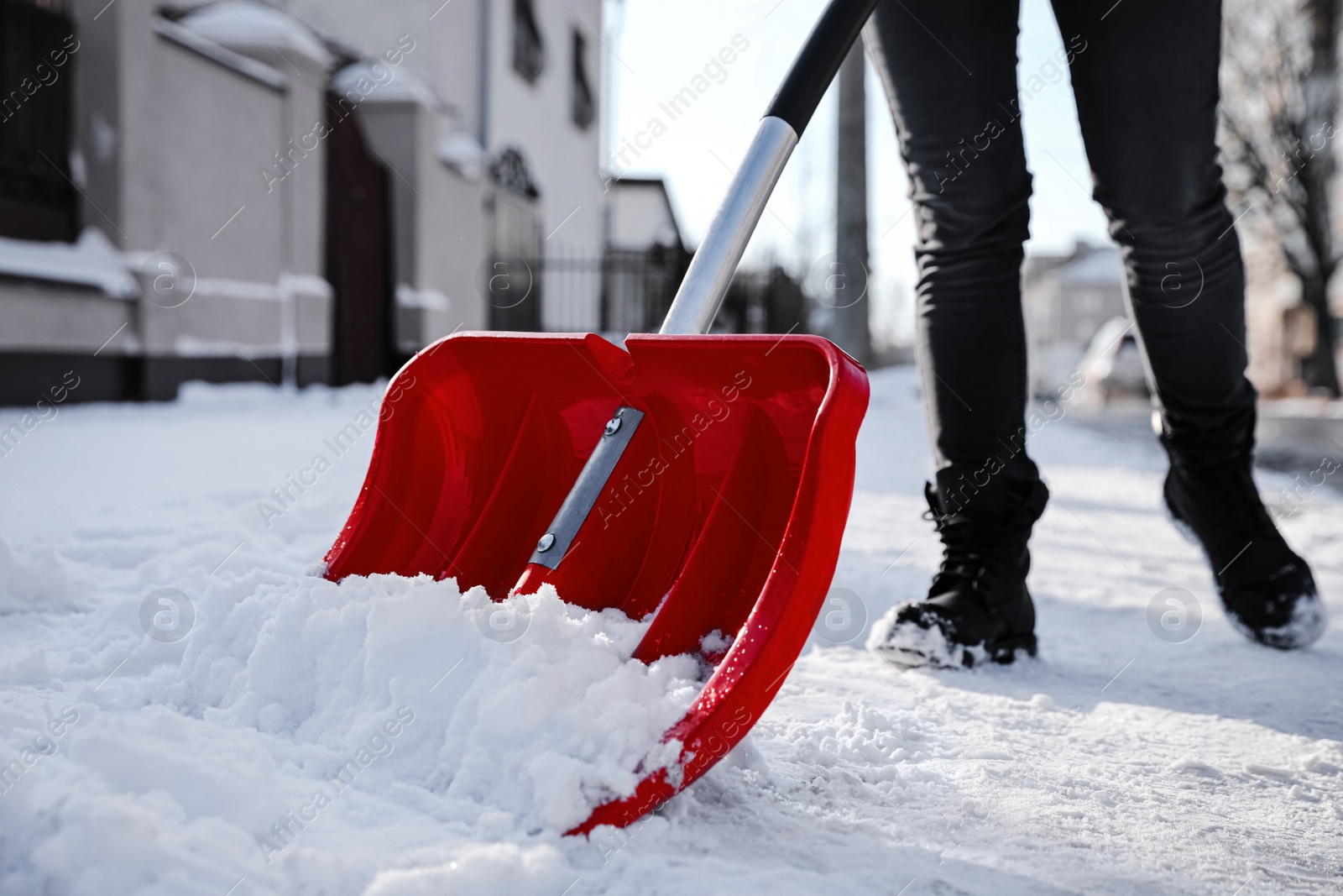 Photo of Person shoveling snow outdoors on winter day, closeup