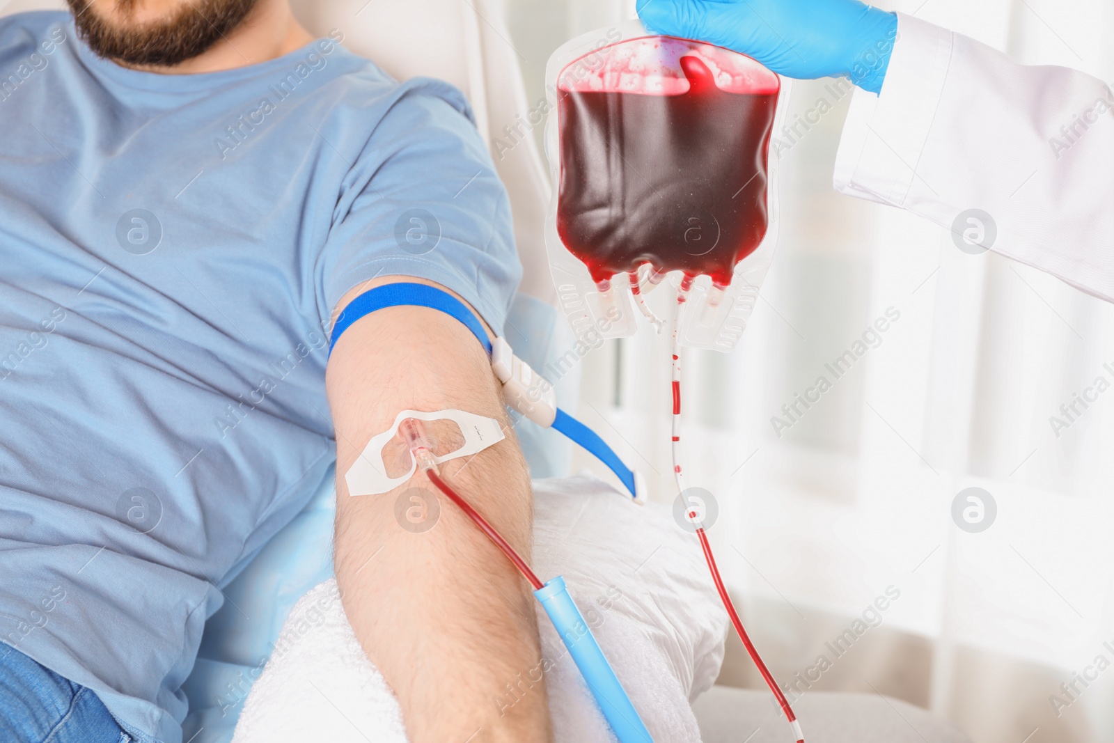 Photo of Man donating blood to save someone's life in hospital