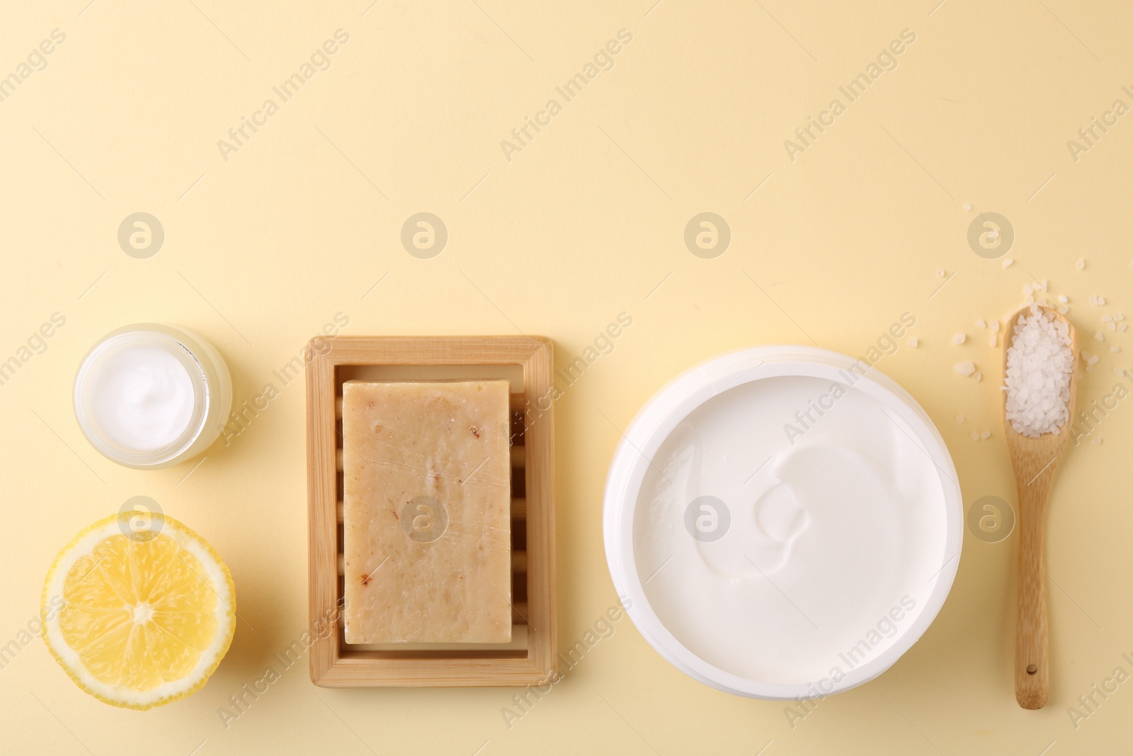 Photo of Flat lay composition with jars of cream on beige background. Space for text