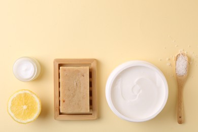 Flat lay composition with jars of cream on beige background. Space for text