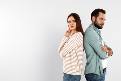 Photo of Couple with relationship problems on light background