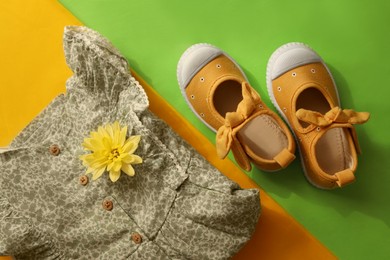 Photo of Stylish child clothes and shoes on color background, flat lay