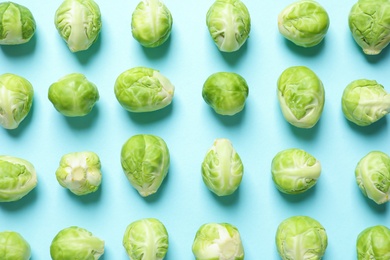 Photo of Fresh Brussels sprouts on color background, flat lay