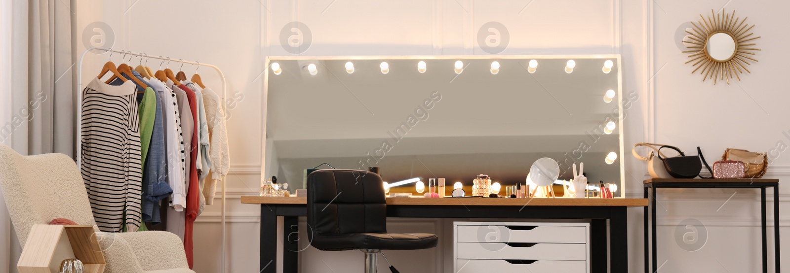 Image of Makeup room. Dressing table with mirror, clothing rack and chair indoors, banner design