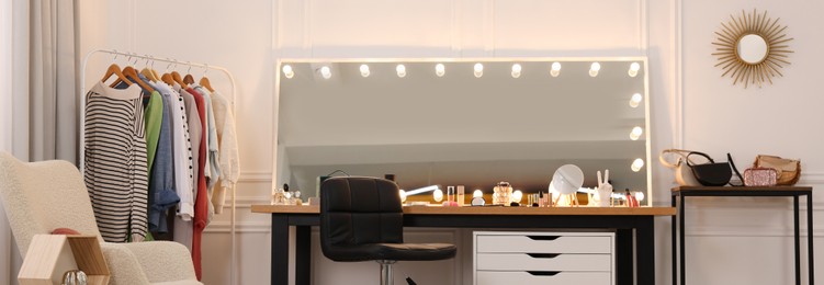 Makeup room. Dressing table with mirror, clothing rack and chair indoors, banner design