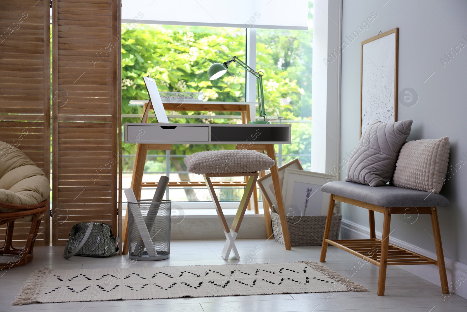 Photo of Stylish room interior with comfortable workplace near window