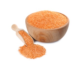 Wooden bowl and scoop with orange salt on white background