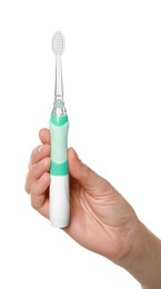 Photo of Woman holding electric toothbrush on white background, closeup