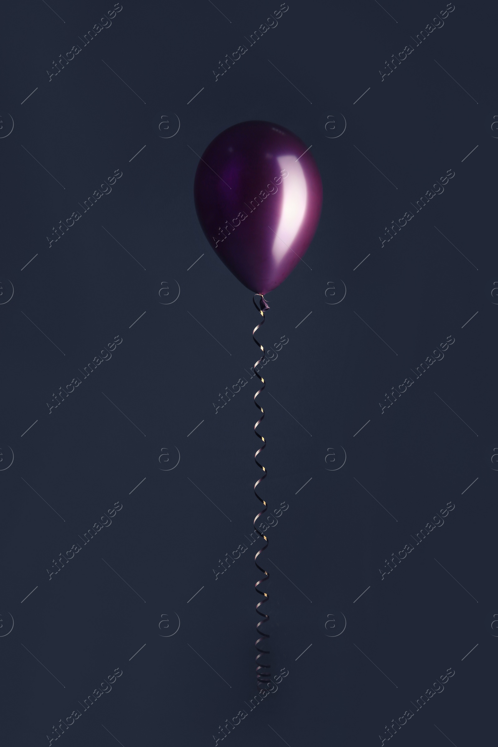 Photo of Color balloon with ribbon on dark background