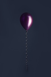 Photo of Color balloon with ribbon on dark background