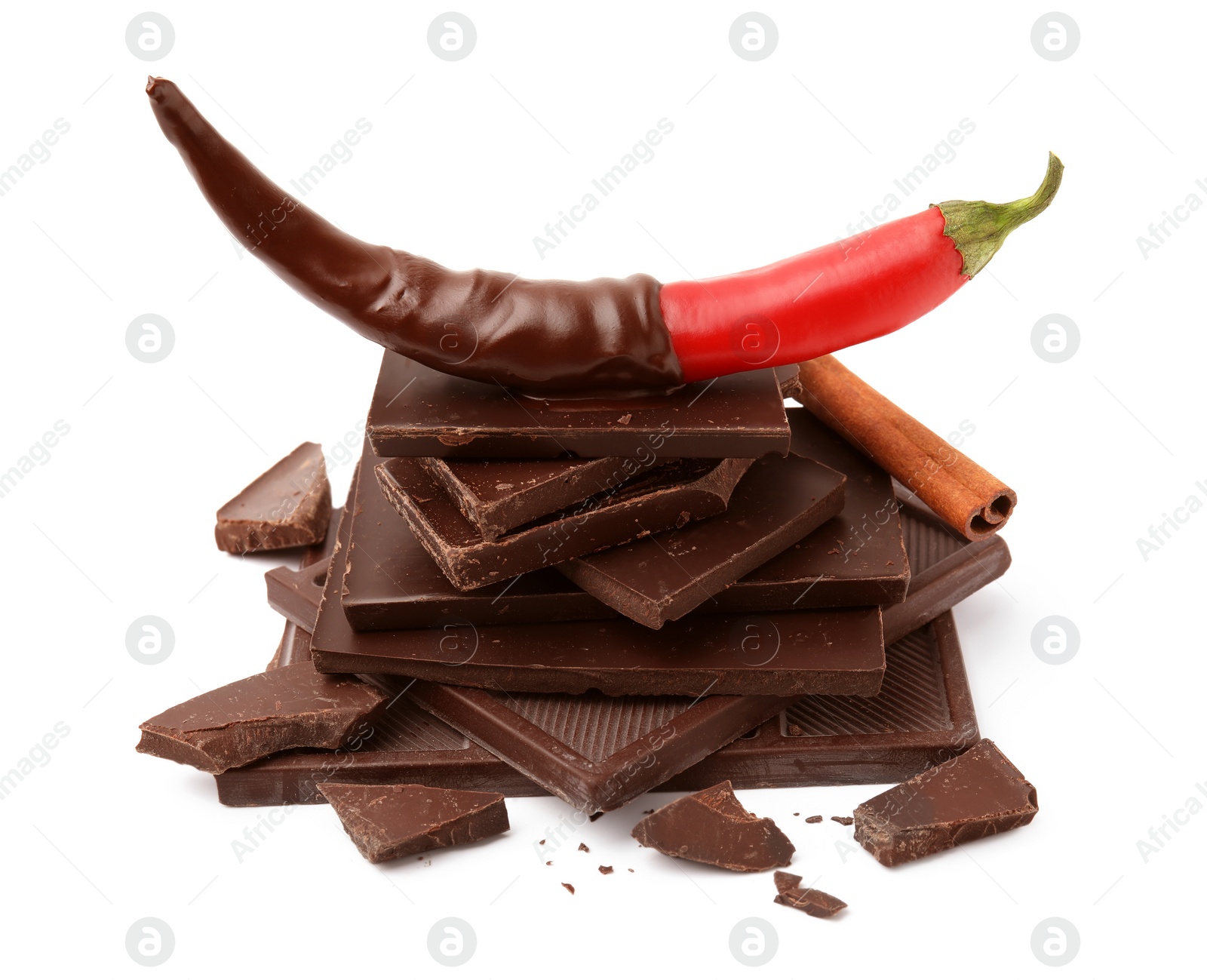 Photo of Red hot chili pepper and dark chocolate with cinnamon isolated on white