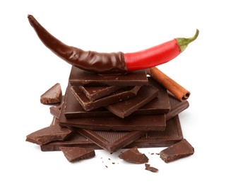 Red hot chili pepper and dark chocolate with cinnamon isolated on white