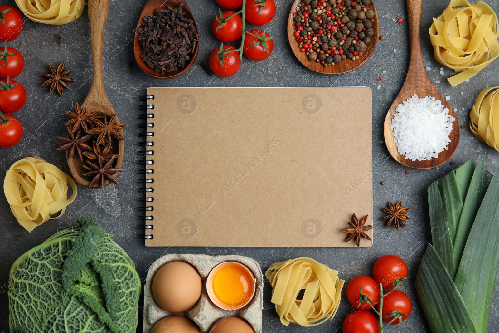 Photo of Notebook and different fresh products on grey table, flat lay with space for text. Cooking Classes