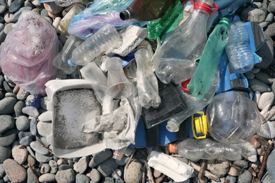 Photo of Pile of garbage on stones outdoors, top view. Environmental Pollution concept