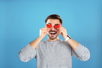 Photo of Man with decorative hearts on color background