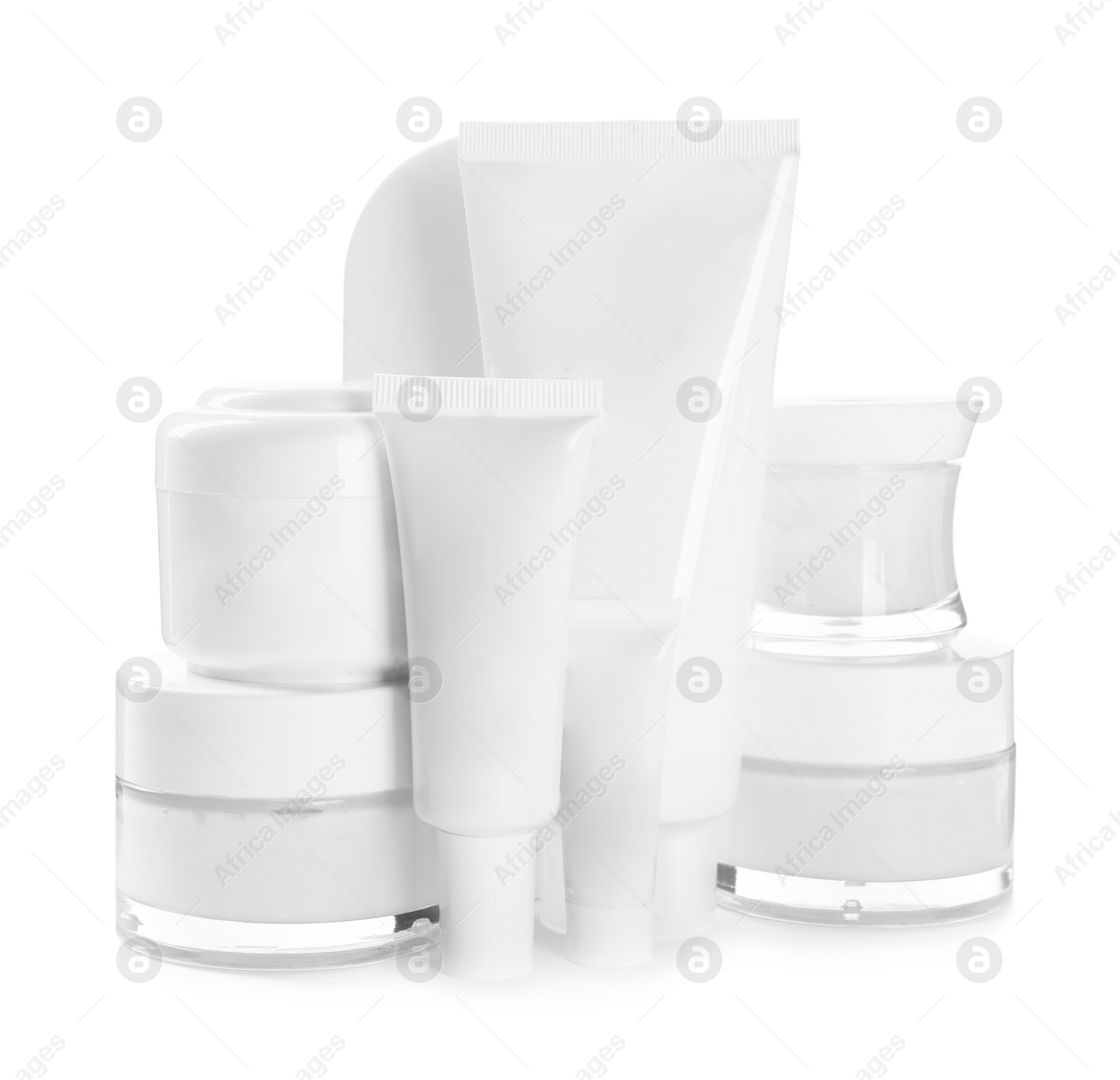 Photo of Blank tubes and jars of cosmetic products on white background