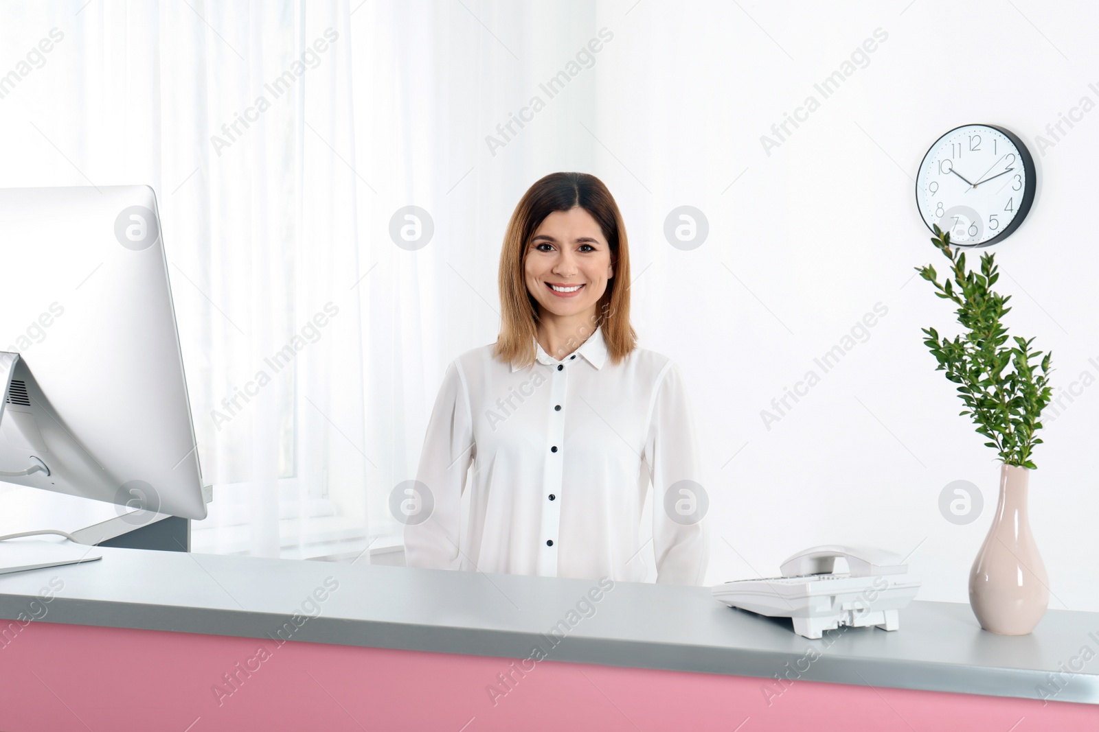 Photo of Portrait of beautiful woman at reception desk in beauty salon