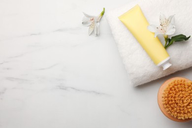 Photo of Flat lay composition with spa products and flowers on white marble table. Space for text