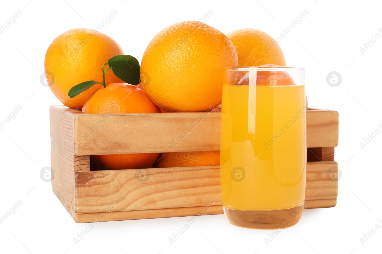 Photo of Fresh oranges in wooden crate and glass of juice isolated on white