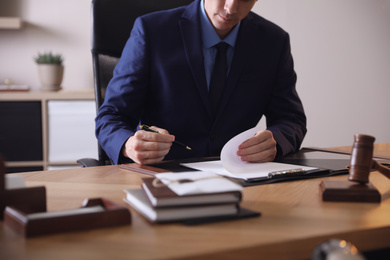 Male lawyer working at table in office, closeup