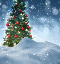 Snow and beautiful decorated Christmas tree. Bokeh effect