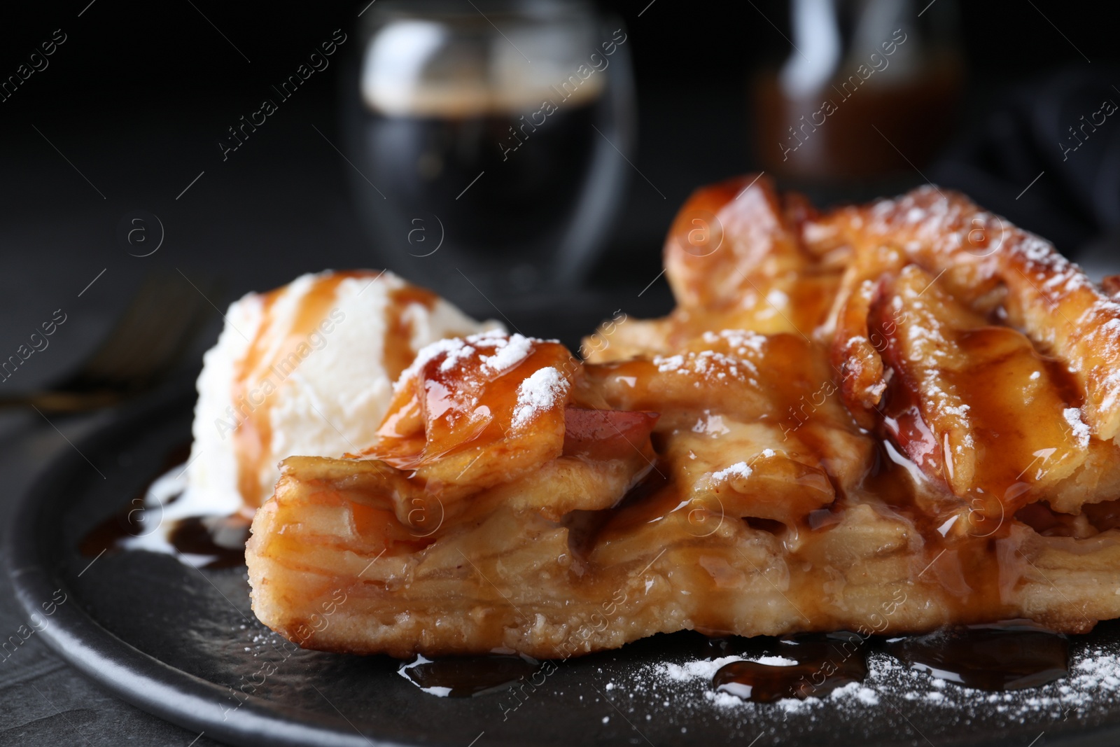 Photo of Slice of traditional apple pie with ice cream on plate, closeup