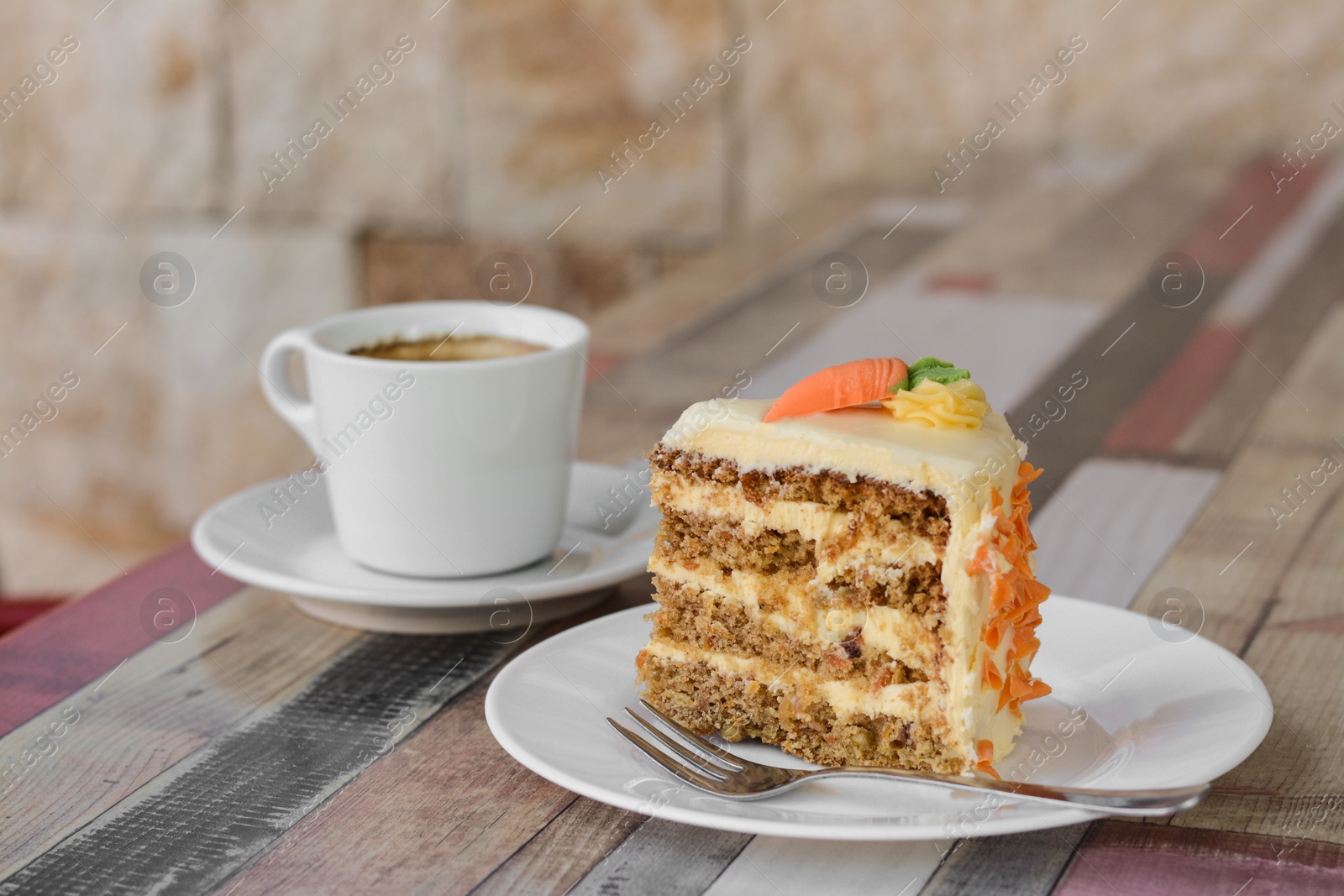 Photo of Delicious cake and cup of hot coffee on wooden table