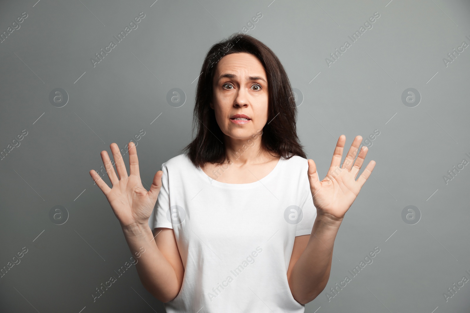 Photo of Mature woman feeling fear on grey background