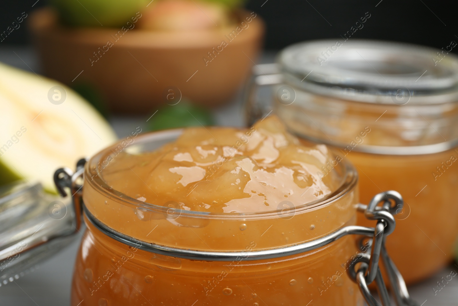 Photo of Delicious pear jam in glass jar, closeup